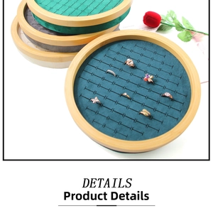 Detail view of round bamboo jewelry trays with multi-slot velvet inserts for rings