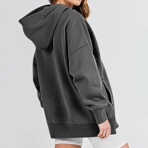 Side view of dark grey oversized hoodie featuring drop shoulders and large kangaroo pocket