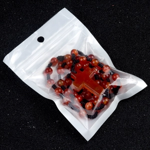 Red agate crystal rosary beads necklace with cross pendant in transparent packaging