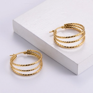 Golden multi-layer twisted rope hoop earrings with a high-polished metallic finish