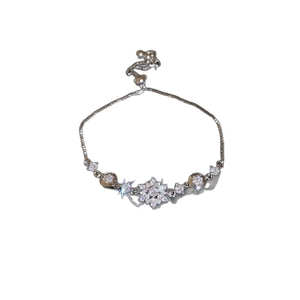 Elegant adjustable silver flower bracelet with sparkling cubic zirconia on white background