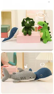 Detailed view of hand-knitted dinosaur and shark plush dolls with soft cotton texture