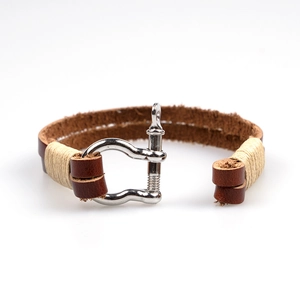 Handmade woven brown leather bracelet with silver horseshoe shackle and cord wrap