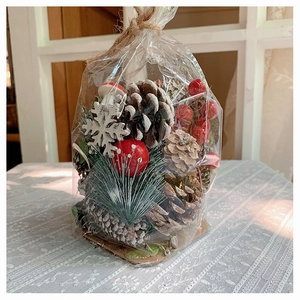 DIY Christmas decoration set with pine cones, red berries and snowflakes on lace cloth