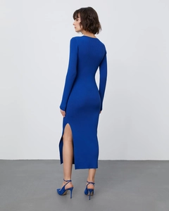 Detailed view of royal blue ribbed knit dress showing the high side slit and long hem