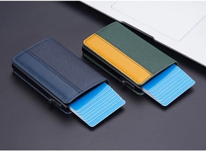 Detail of RFID leather card holders with automatic pop-up mechanism in navy and green
