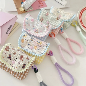 Detailed view of quilted cotton CCD camera bags with floral prints and cute bear patterns