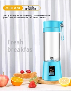 Close-up of portable mini electric juicer with blue base, steel blades and fresh fruits