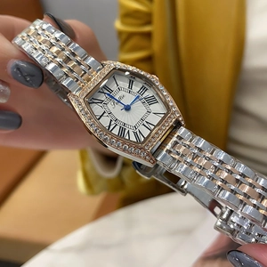 Macro shot of tonneau watch featuring diamond-set bezel and elegant Roman numerals