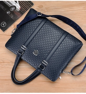 Detailed shot of textured blue synthetic leather briefcase with silver hardware and strap