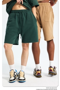 Close-up of vintage heavy cotton drawstring shorts in deep green and khaki tones