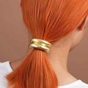 Elegant gold metallic double-ring hair tie shown on a sleek ponytail from the back