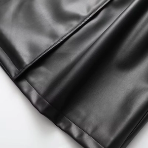 Close-up of the smooth black PU leather hemline showing premium texture and soft folds