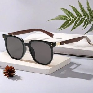 Close-up of vintage polygonal sunglasses with wood grain temples and metal hinge details