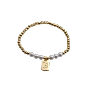 Close-up of gold beads and white pearls bracelet with a square letter B charm