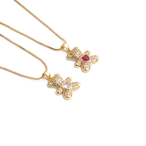 Golden bear pendant necklace with crystal heart stone on an elegant box chain
