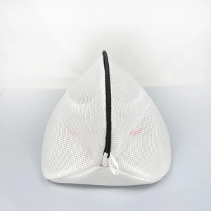 Detailed close-up of a white mesh laundry bag with a black zipper for washing shoes