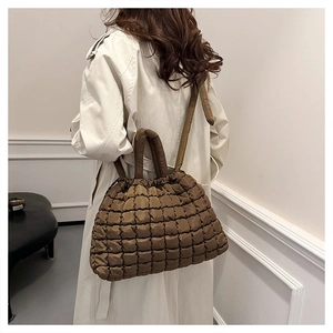 Deep brown quilted nylon tote bag with bubble texture and padded shoulder strap detail
