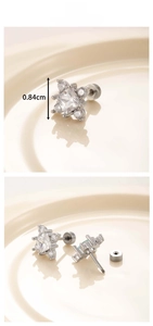 Detailed view of silver snowflake earrings with sparkling cubic zirconia and screw backs