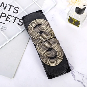 Women's wide elastic waist belt with vintage bronze woven buckle on marble surface
