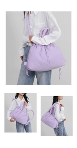 Macro view of purple padded puffer tote bag with drawstring closure and soft handles
