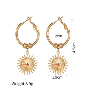 Detailed view of gold sunburst earrings with pink rhinestones and dimension markings
