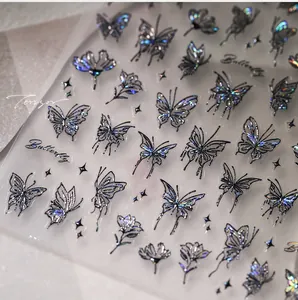 Macro shot of laser holographic butterfly nail stickers with metallic aurora finish