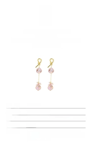 Macro view of 18k gold plated S925 silver knots and baroque pearls on earrings