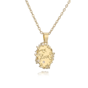 Gold LOVE necklace with oval pendant featuring floral design and crystal accents