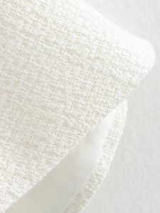 Detail shot of white tweed fabric texture and lightweight lining for a women jacket