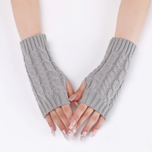 Detail of grey cable knit fingerless gloves showing warmth and texture on a white background