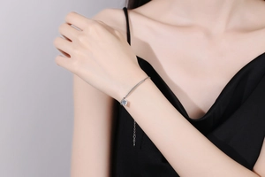 Close-up of S925 sterling silver bracelet with 1 carat moissanite on female wrist