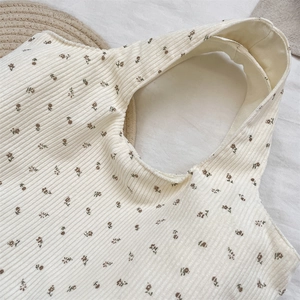Detailed close-up of beige corduroy tote bag with vintage brown floral pattern texture