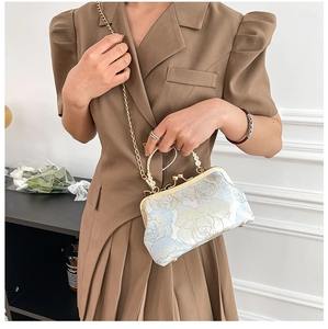 Detail of vintage evening bag with blue rose embroidery and elegant pearl handle