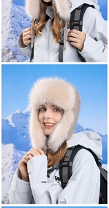 Close-up of thick plush faux fur lining on a beige winter trapper hat for outdoor warmth