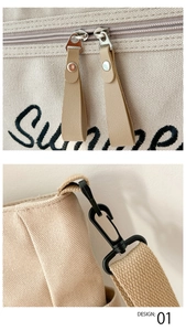 Detail of the dual zipper closure and metal strap hook on beige canvas tote bag
