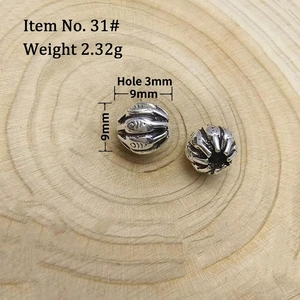 Macro shot of 9mm retro silver fish beads for DIY jewelry with 3mm center hole