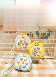 Close-up of duck-shaped silicone fidget toy with colorful press buttons and lanyards