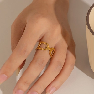 Detailed view of an 18k gold plated stainless steel irregular link ring on a model hand