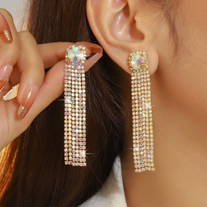 Sparkling long tassel earrings with iridescent rhinestones and round crystal in gold finish
