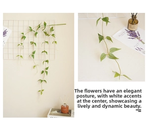 Detail of artificial clematis vine featuring realistic green leaves with white accents
