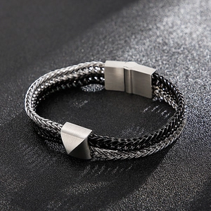 Macro shot of silver and black woven dragon bone chain with pyramid metal studs