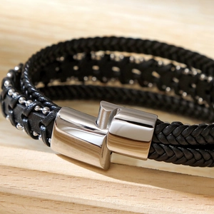 Close-up of double-layer braided leather bracelet with polished silver metal buckle