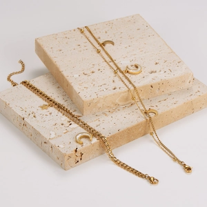 Gold double-layered stainless steel bracelet with star and moon charms on stone blocks
