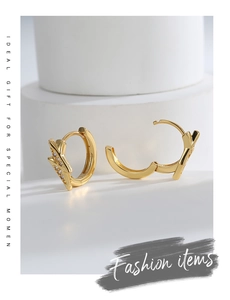 Detail of 925 silver gold hoop earrings with sparkling zircon inlay and hallmark
