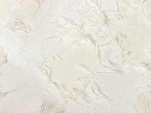 Macro-opname van elegante crèmewitte jacquardstof met veren franje textuur detail