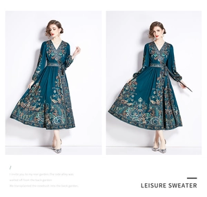 Detail of teal paisley maxi dress with V-neckline and tie waist for elegant women