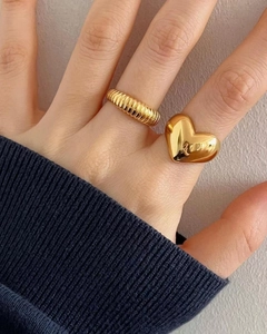 Polished 925 sterling silver heart ring and gold croissant ring worn on hand
