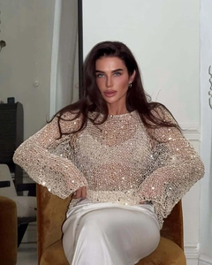 Detailed view of beige sequined mesh knit sweater featuring a stylish hollow-out design