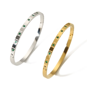Minimalist gold and silver stainless steel bangles set with round emerald zircons